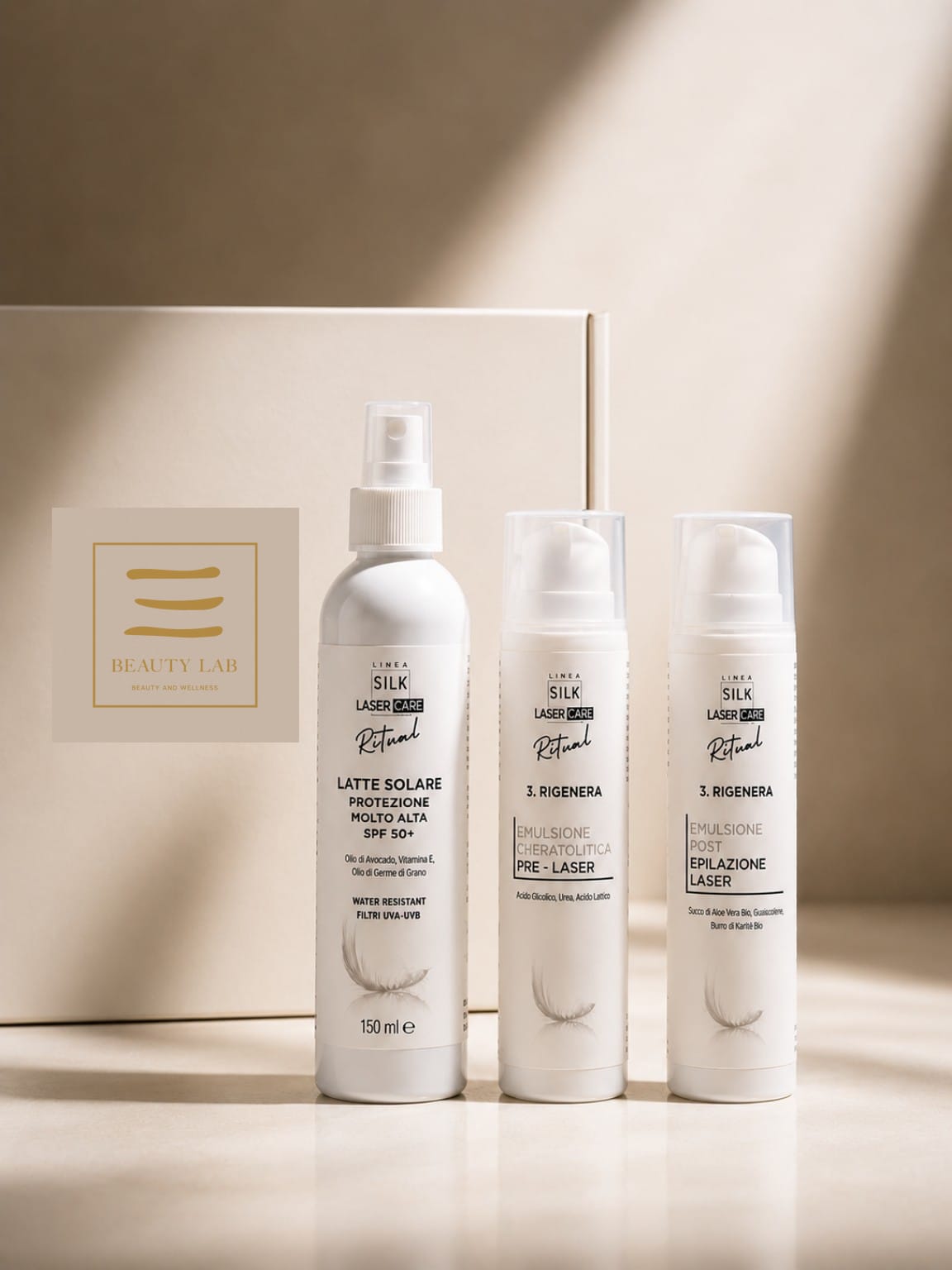 Tre flaconi della linea LINEA SILK Laser Care Ritual® davanti alla loro confezione color crema.